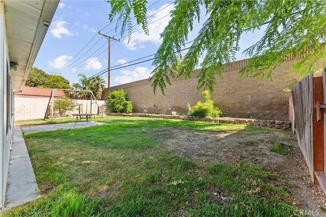 a view of a yard with plants and a slide
