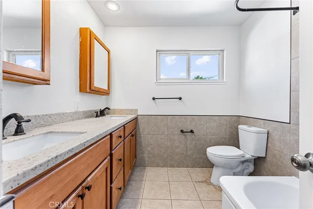 a bathroom with a granite countertop sink mirror bathtub and shower