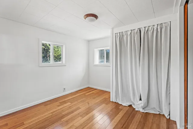 a view of a room with wooden floor and entryway