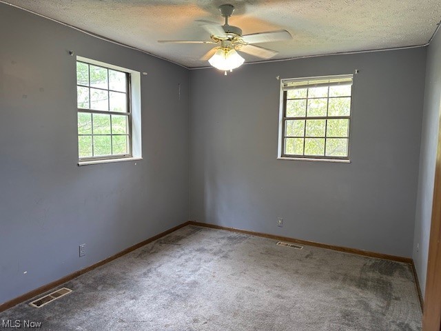 160 Arends Ridge Road Marietta, OH 45750 - Photo 13 of 19 Carpeted spare room with ceiling fan and a textured ceiling