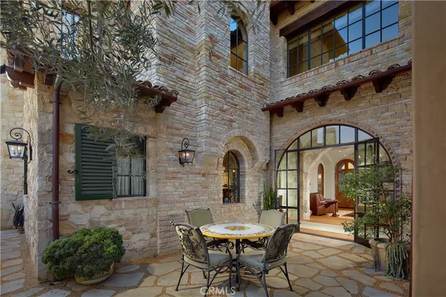 a view of a brick building with a table and chairs