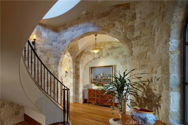 a view of staircase with wooden floor and a potted plant