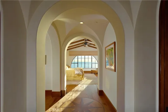 a spacious bedroom with a bed a dresser next to a window