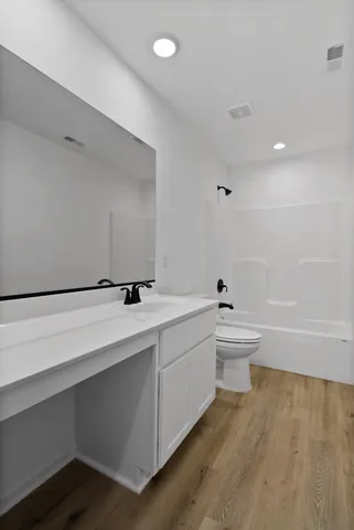a bathroom with a sink a toilet and bathtub