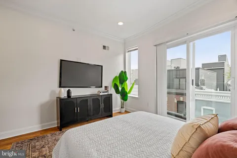 a bedroom with a bed and a flat screen tv