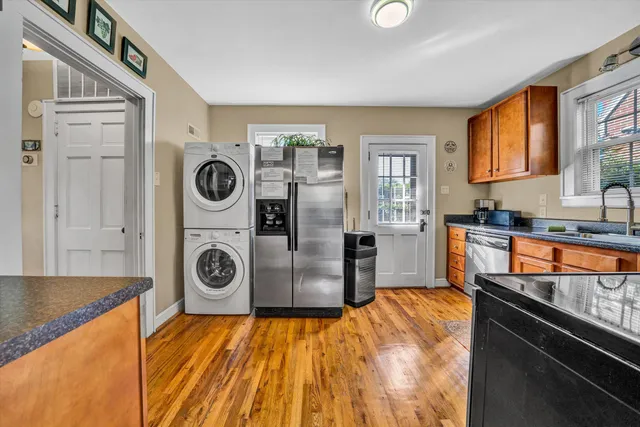 a living room with furniture and kitchen view