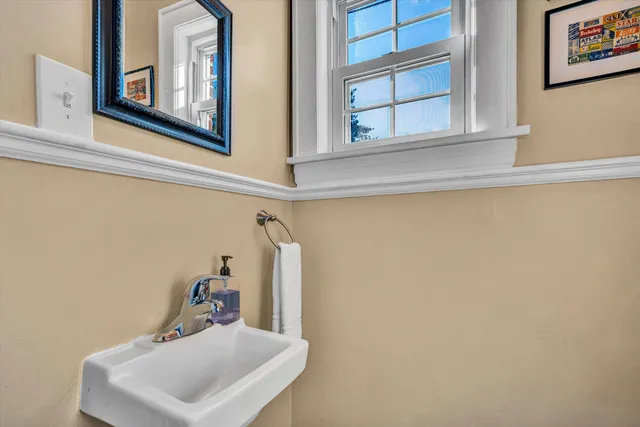 a view of backyard with potted plants and wooden fence