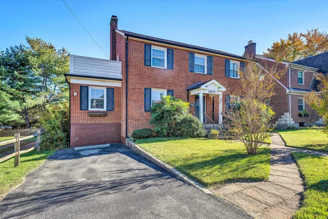 a front view of house with yard and green space