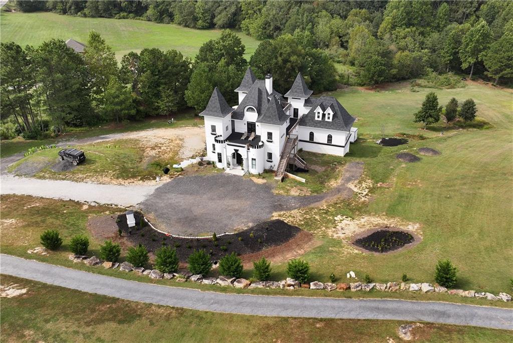 an aerial view of a house with yard swimming pool and outdoor seating