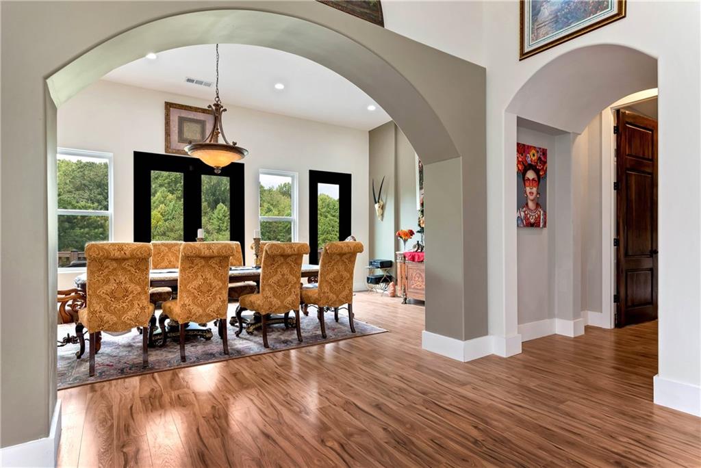 1197 Dee Kennedy Road Auburn, GA 30011 - Photo 13 of 78 a view of a dining room with furniture window and wooden floor