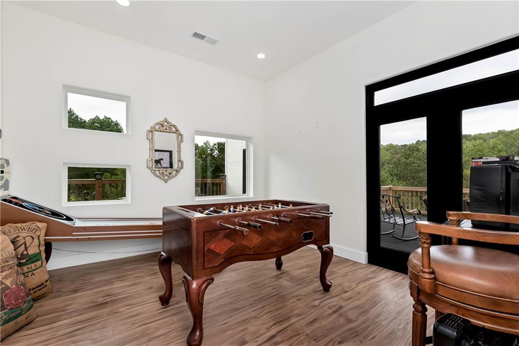 1197 Dee Kennedy Road Auburn, GA 30011 - Photo 33 of 78 a living room with furniture a flat screen tv and a floor to ceiling window