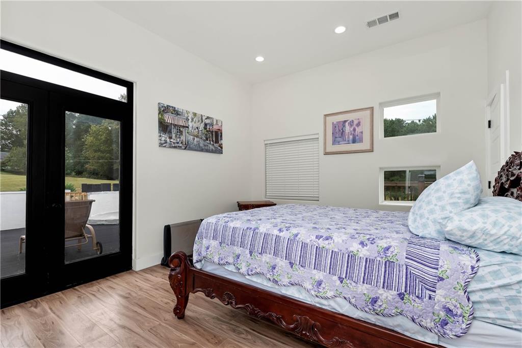 1197 Dee Kennedy Road Auburn, GA 30011 - Photo 35 of 78 a bedroom with a bed and wooden floor