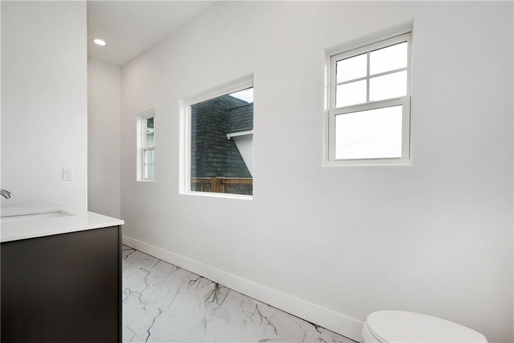 1197 Dee Kennedy Road Auburn, GA 30011 - Photo 38 of 78 a bathroom with a toilet sink and window