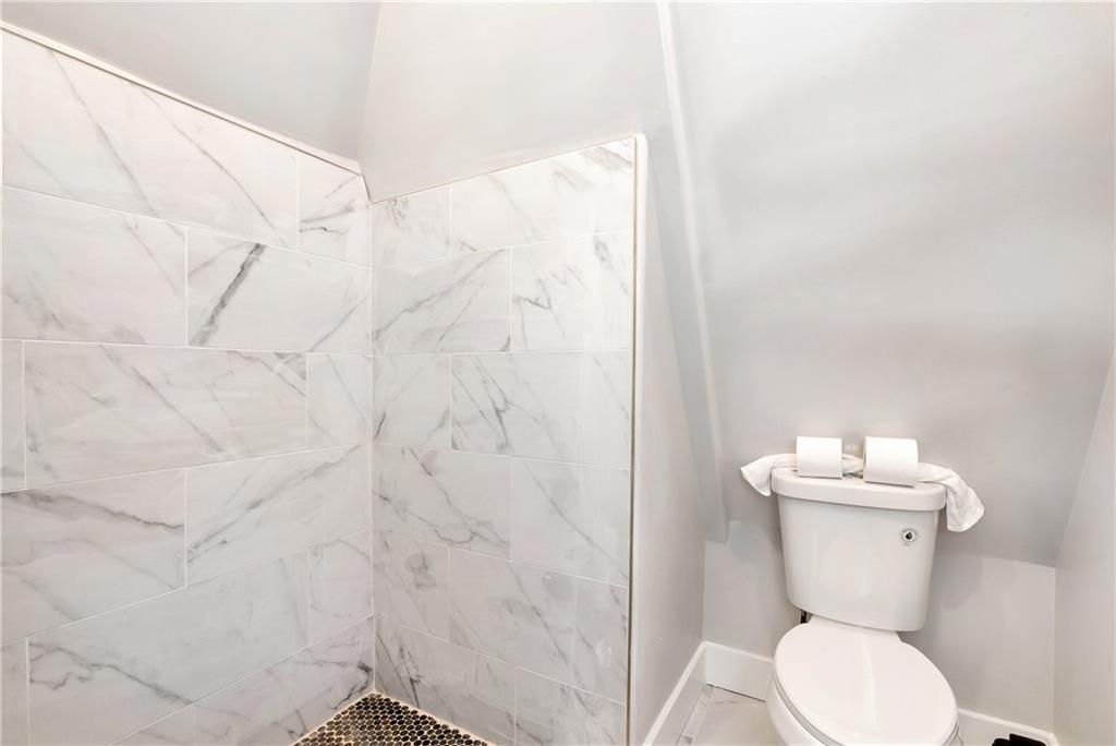 1197 Dee Kennedy Road Auburn, GA 30011 - Photo 47 of 78 a white toilet sitting next to a white sink