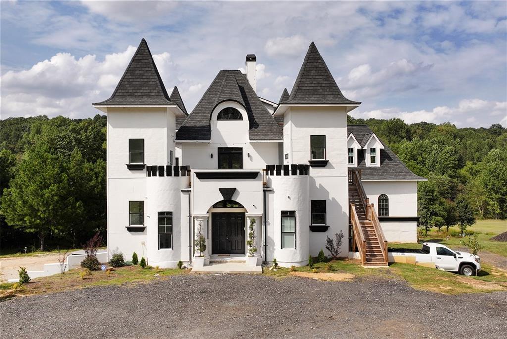 1197 Dee Kennedy Road Auburn, GA 30011 - Photo 5 of 78 a front view of a house with a yard