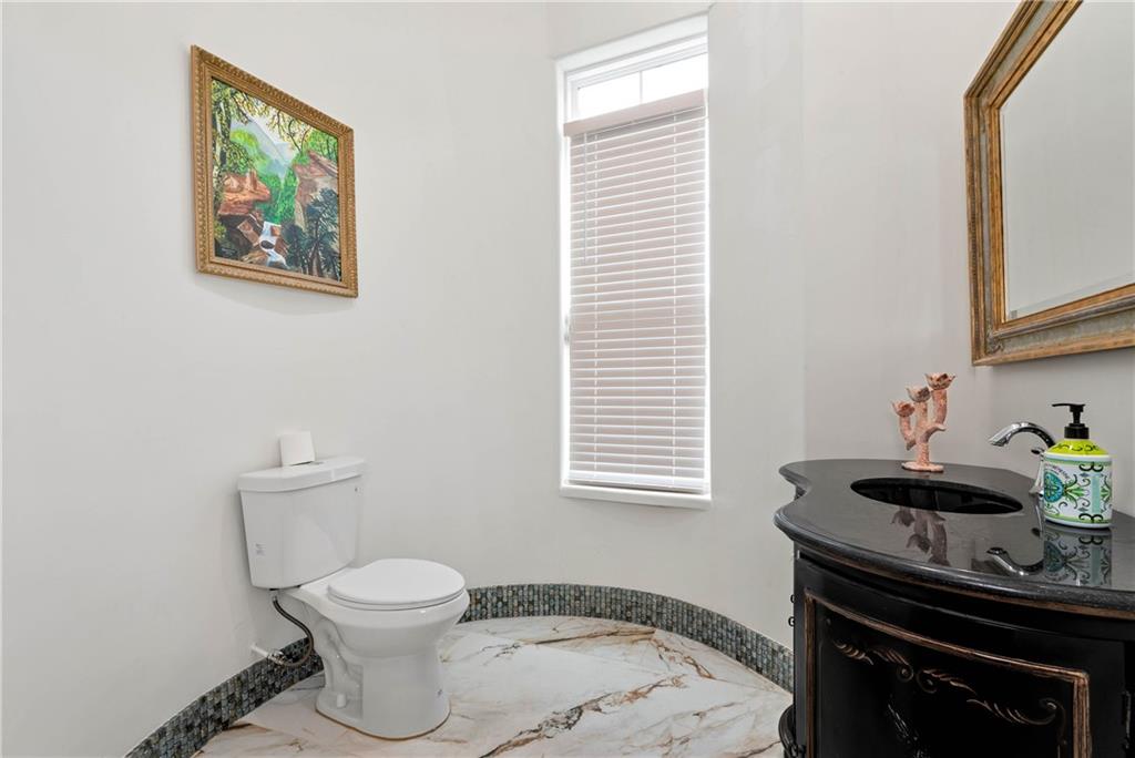 1197 Dee Kennedy Road Auburn, GA 30011 - Photo 55 of 78 a bathroom with a toilet a sink and a window
