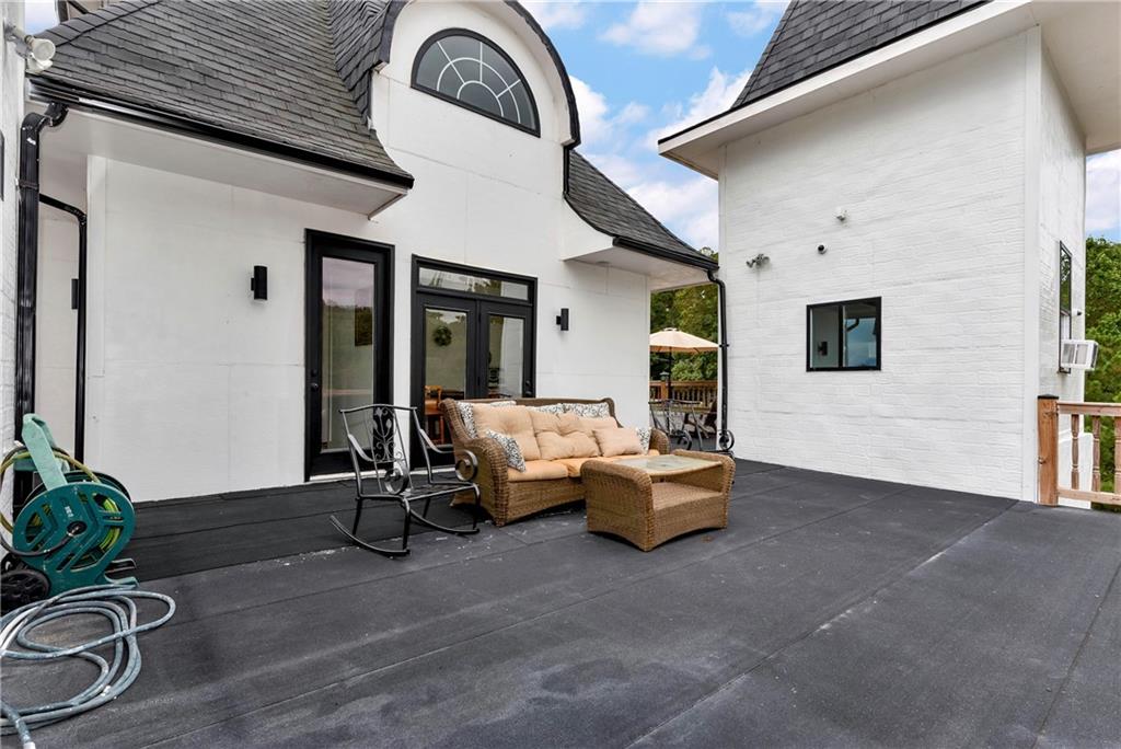 1197 Dee Kennedy Road Auburn, GA 30011 - Photo 58 of 78 a living room with furniture and potted plants