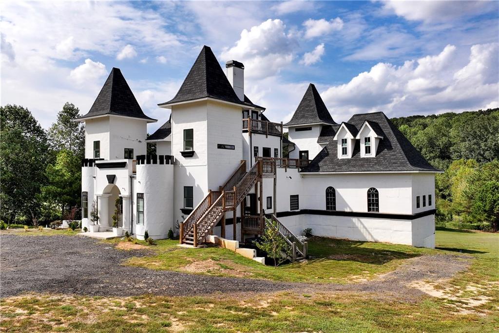 1197 Dee Kennedy Road Auburn, GA 30011 - Photo 6 of 78 a view of a big house with large trees in front of it