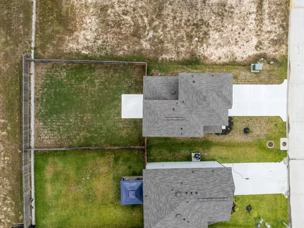 a aerial view of a house with a yard