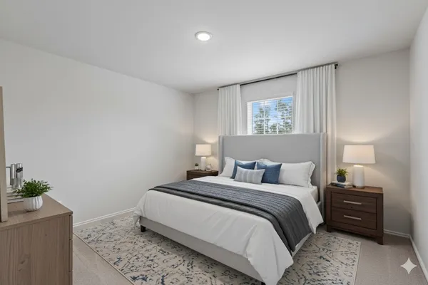 a bedroom with a bed and a potted plant