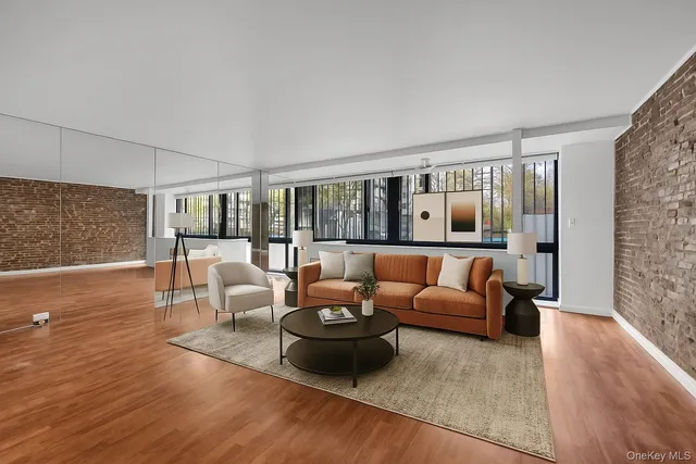 a living room with furniture and a floor to ceiling window