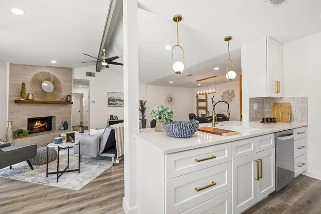 a kitchen with a sink cabinets and wooden floor