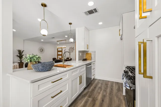 a kitchen with sink and refrigerator