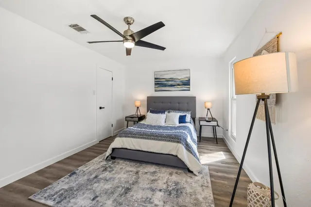 a bedroom with a bed and a mirror