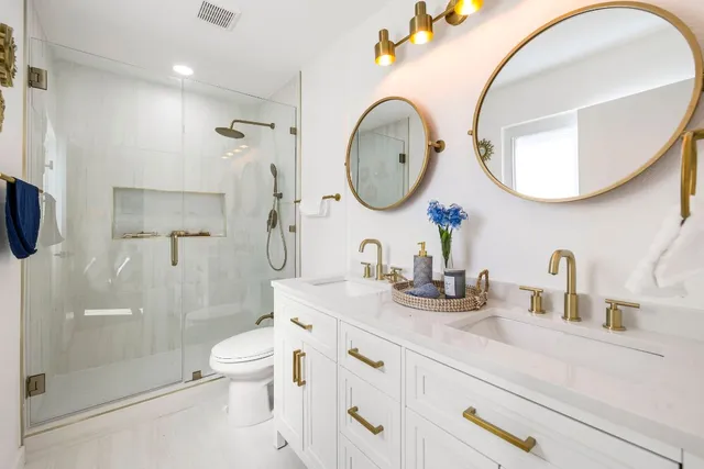 a bathroom with a toilet a sink a mirror and vanity