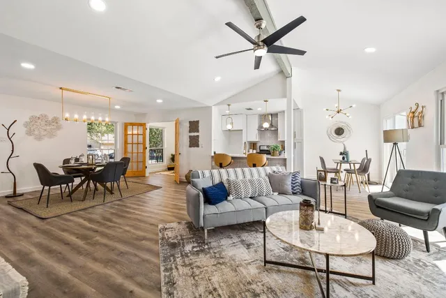 a living room with furniture and a view of kitchen