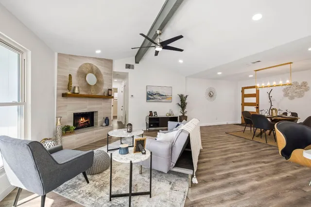 a living room with furniture a fireplace with wooden floor