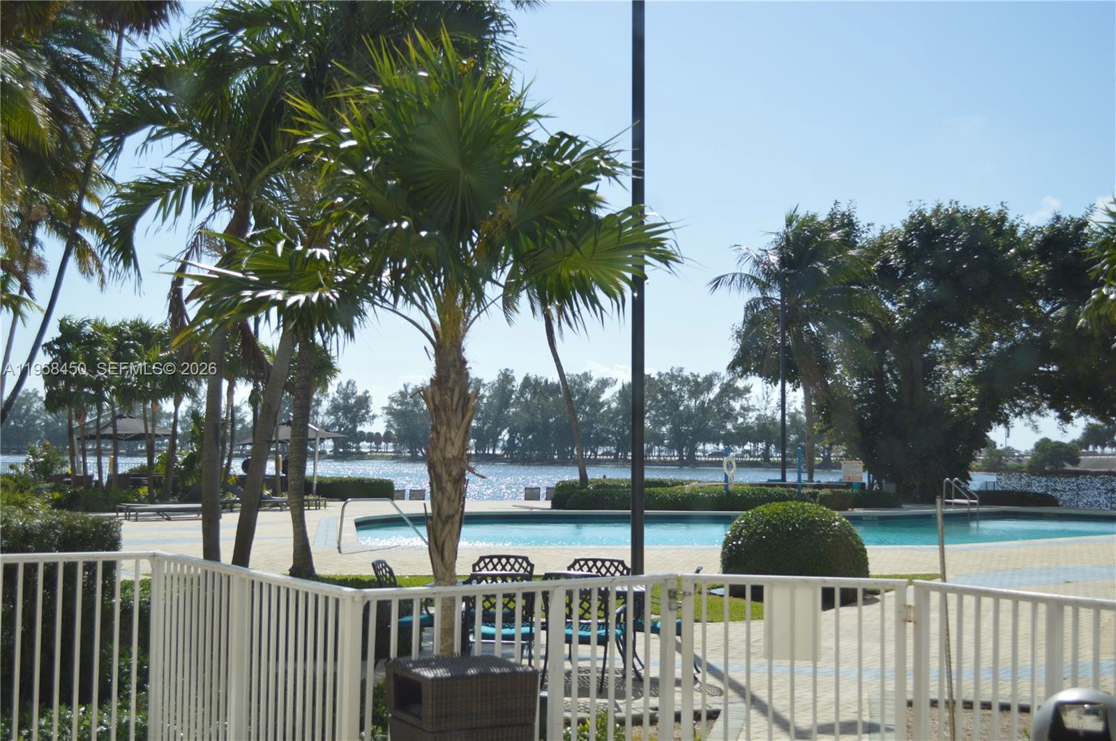 2451 Brickell Avenue, Unit PHM Miami, FL 33129 - Photo 15 of 52 a view of a deck with large trees and wooden fence