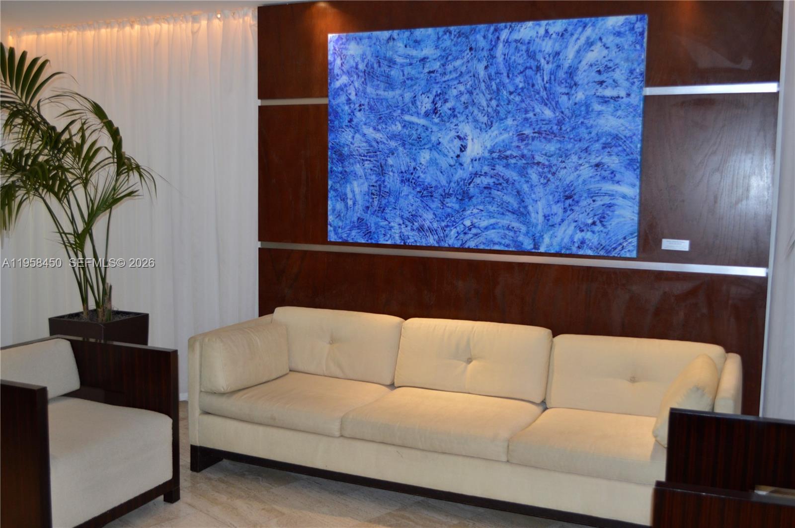 2451 Brickell Avenue, Unit PHM Miami, FL 33129 - Photo 16 of 52 a living room with a couch and a potted plant