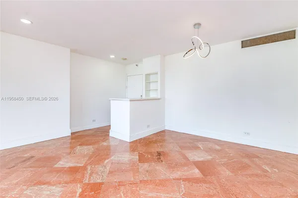 a view of a kitchen with white cabinets and white appliances