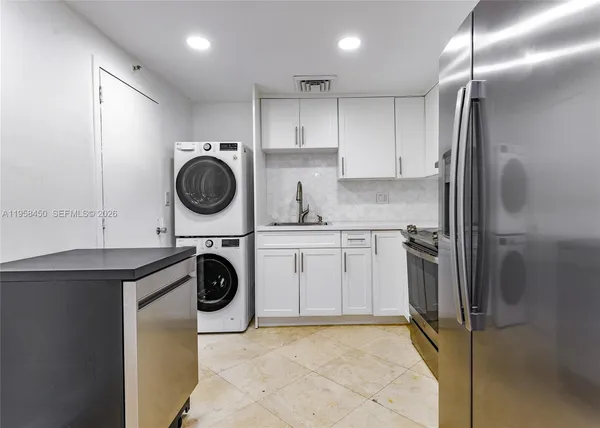 a kitchen with a refrigerator and a sink