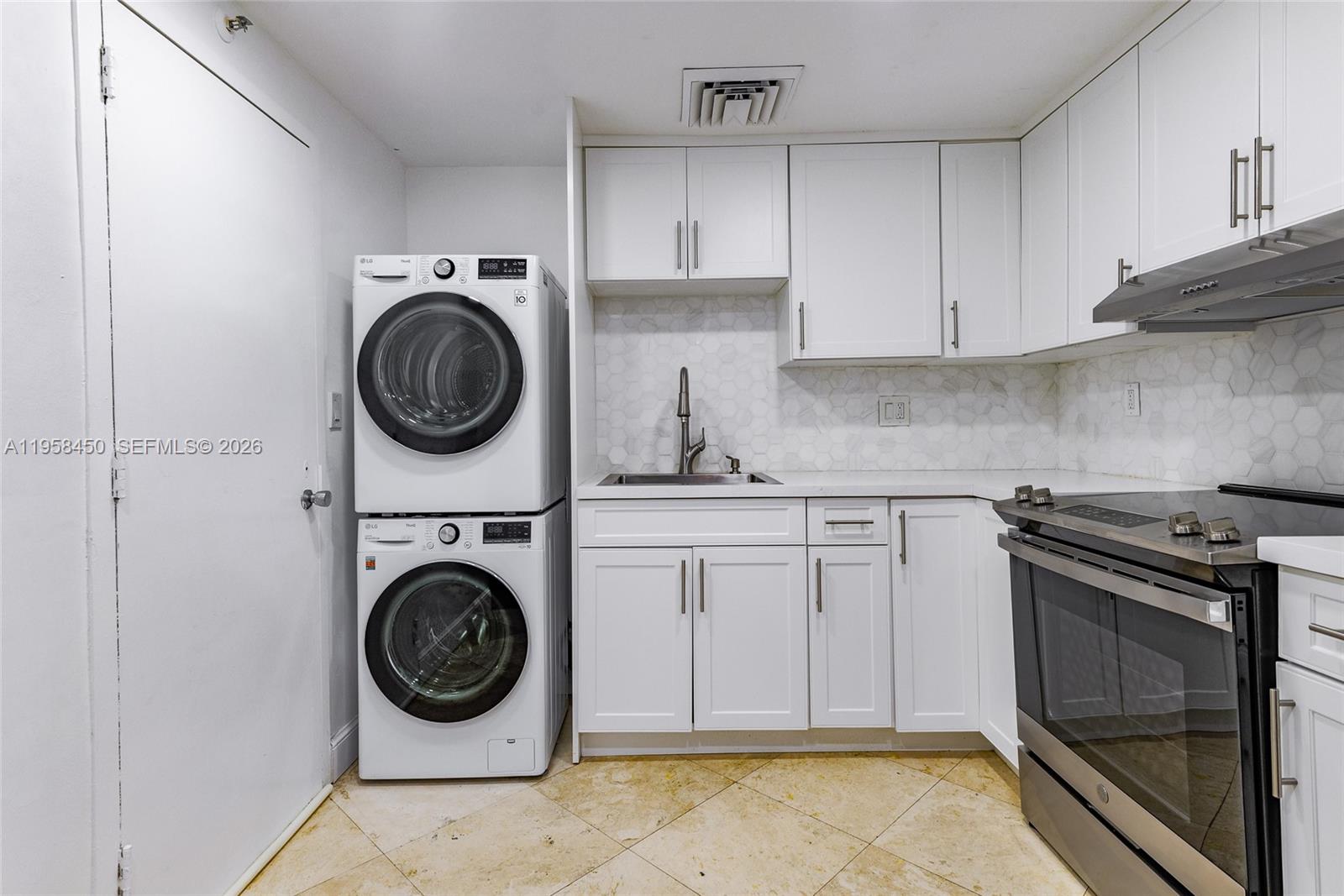2451 Brickell Avenue, Unit PHM Miami, FL 33129 - Photo 20 of 40 a kitchen with a stove top oven sink and cabinets
