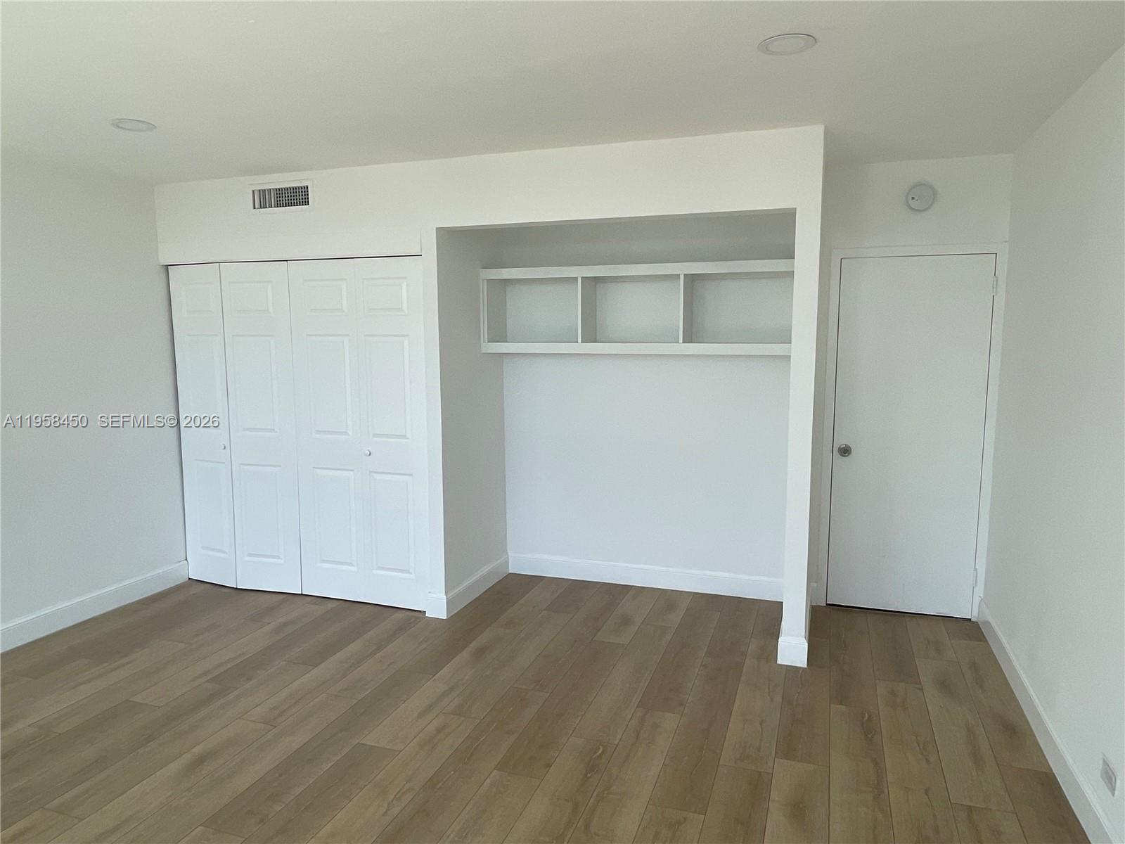 2451 Brickell Avenue, Unit PHM Miami, FL 33129 - Photo 2 of 40 wooden floor in an empty room