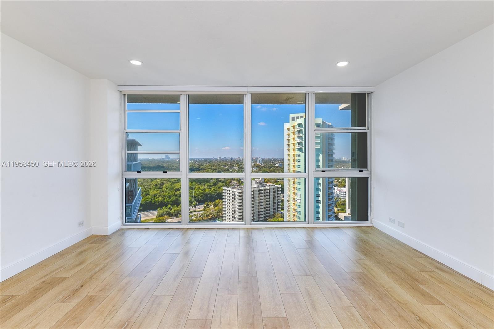 2451 Brickell Avenue, Unit PHM Miami, FL 33129 - Photo 22 of 40 wooden floor in an empty room with a window