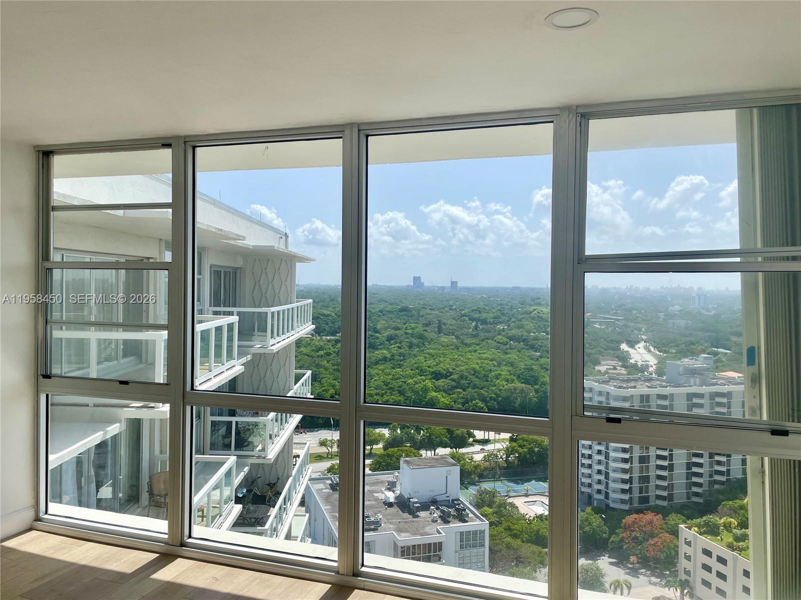 2451 Brickell Avenue, Unit PHM Miami, FL 33129 - Photo 22 of 52 a view of a glass door with a tree