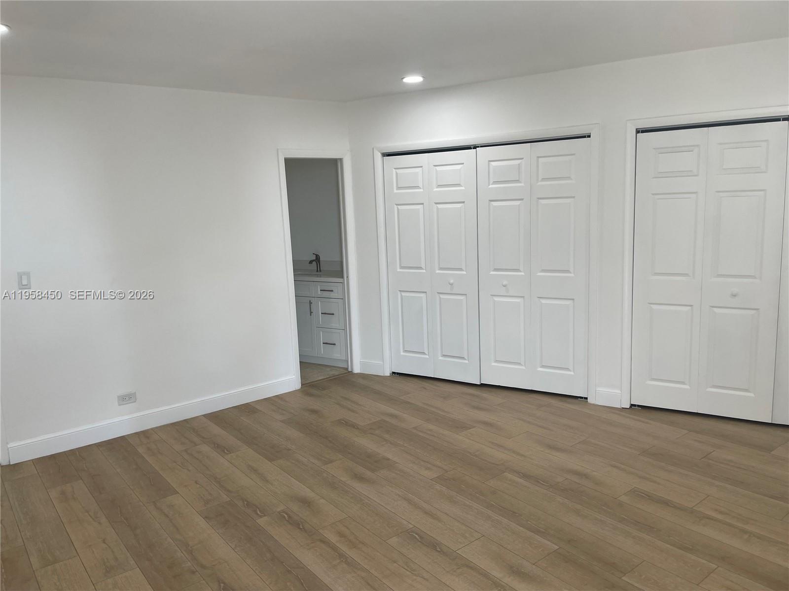 2451 Brickell Avenue, Unit PHM Miami, FL 33129 - Photo 23 of 52 a view of an empty room with wooden floor