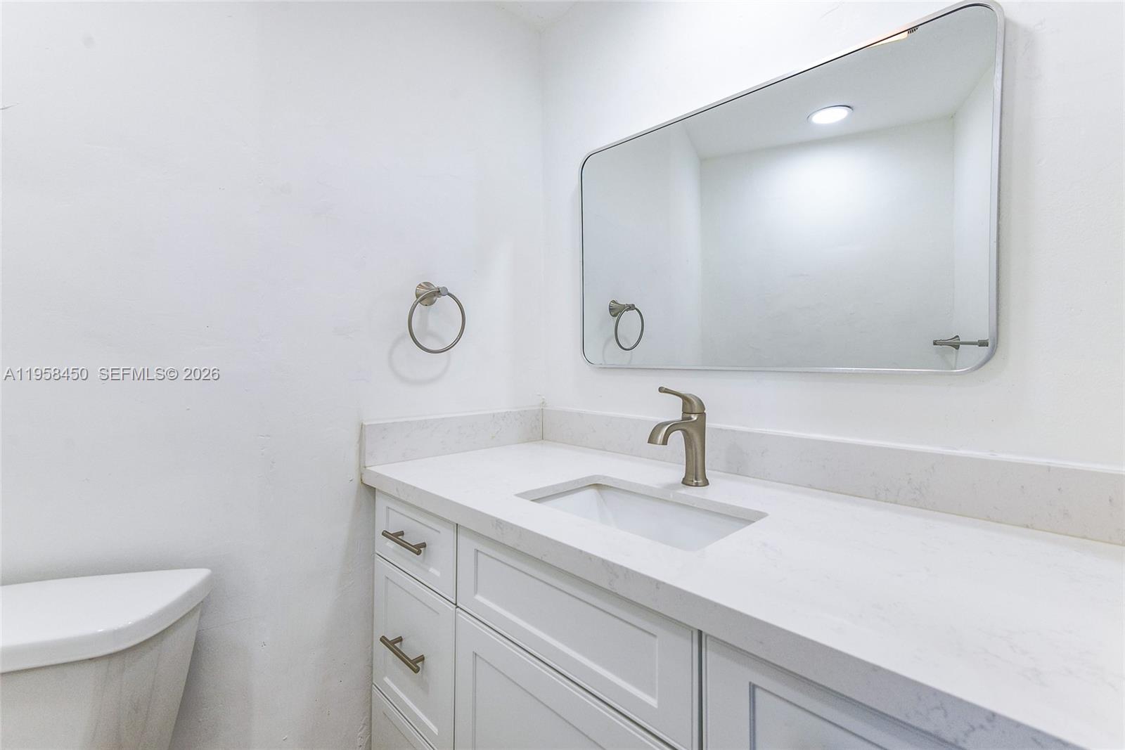 2451 Brickell Avenue, Unit PHM Miami, FL 33129 - Photo 27 of 40 a bathroom with a sink a toilet and a mirror