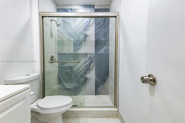 a bathroom with a shower and a toilet