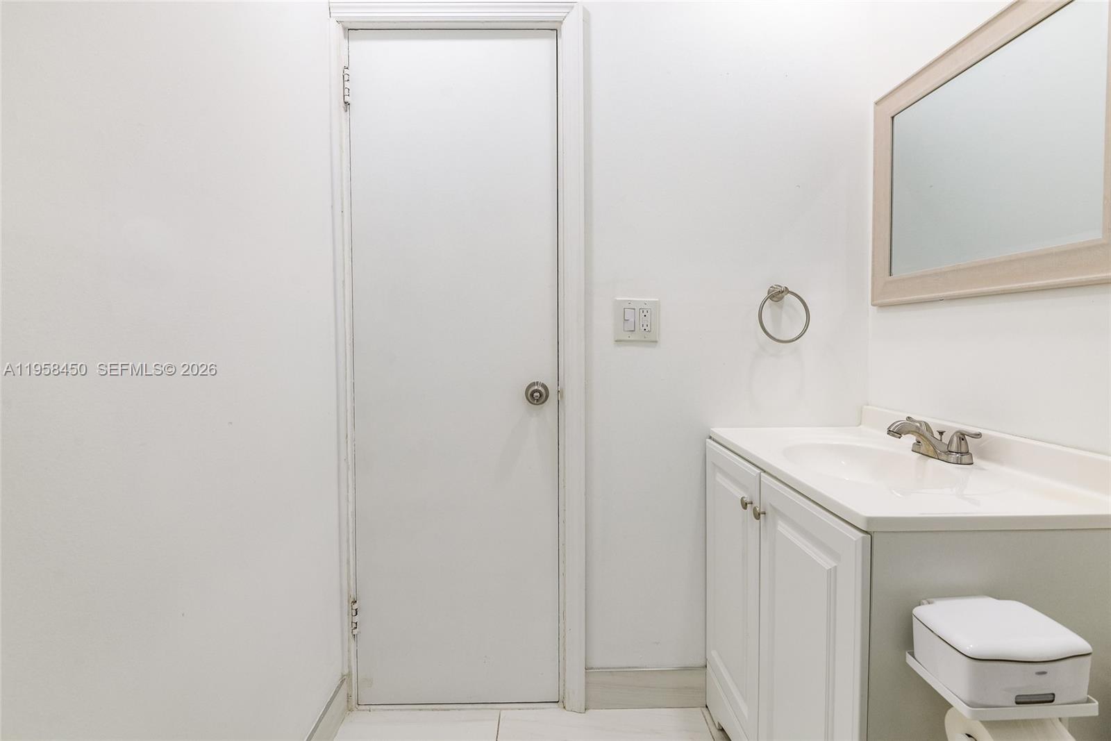 2451 Brickell Avenue, Unit PHM Miami, FL 33129 - Photo 30 of 40 a bathroom with a sink a toilet and a mirror