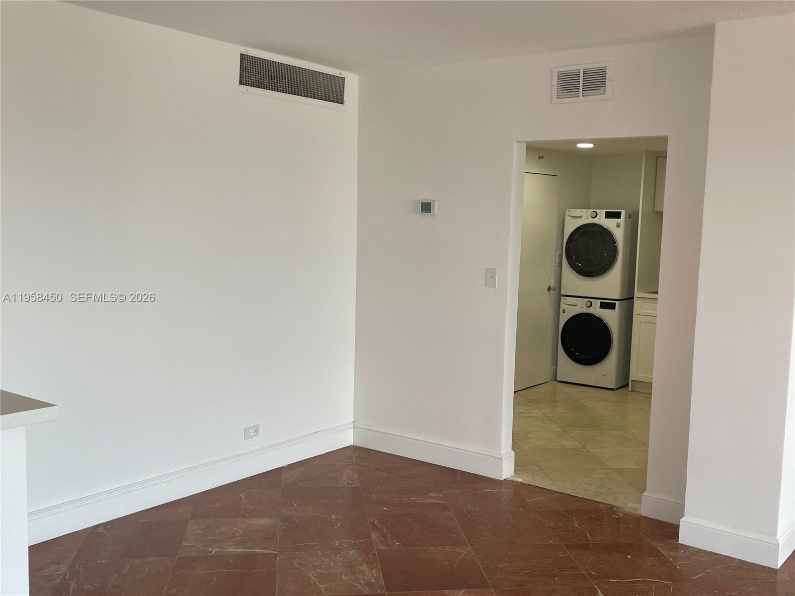 2451 Brickell Avenue, Unit PHM Miami, FL 33129 - Photo 32 of 52 an empty room with wooden floor and windows