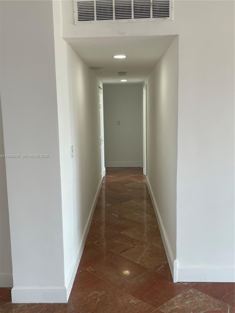 2451 Brickell Avenue, Unit PHM Miami, FL 33129 - Photo 33 of 52 a view of a hallway with wooden floor and staircase