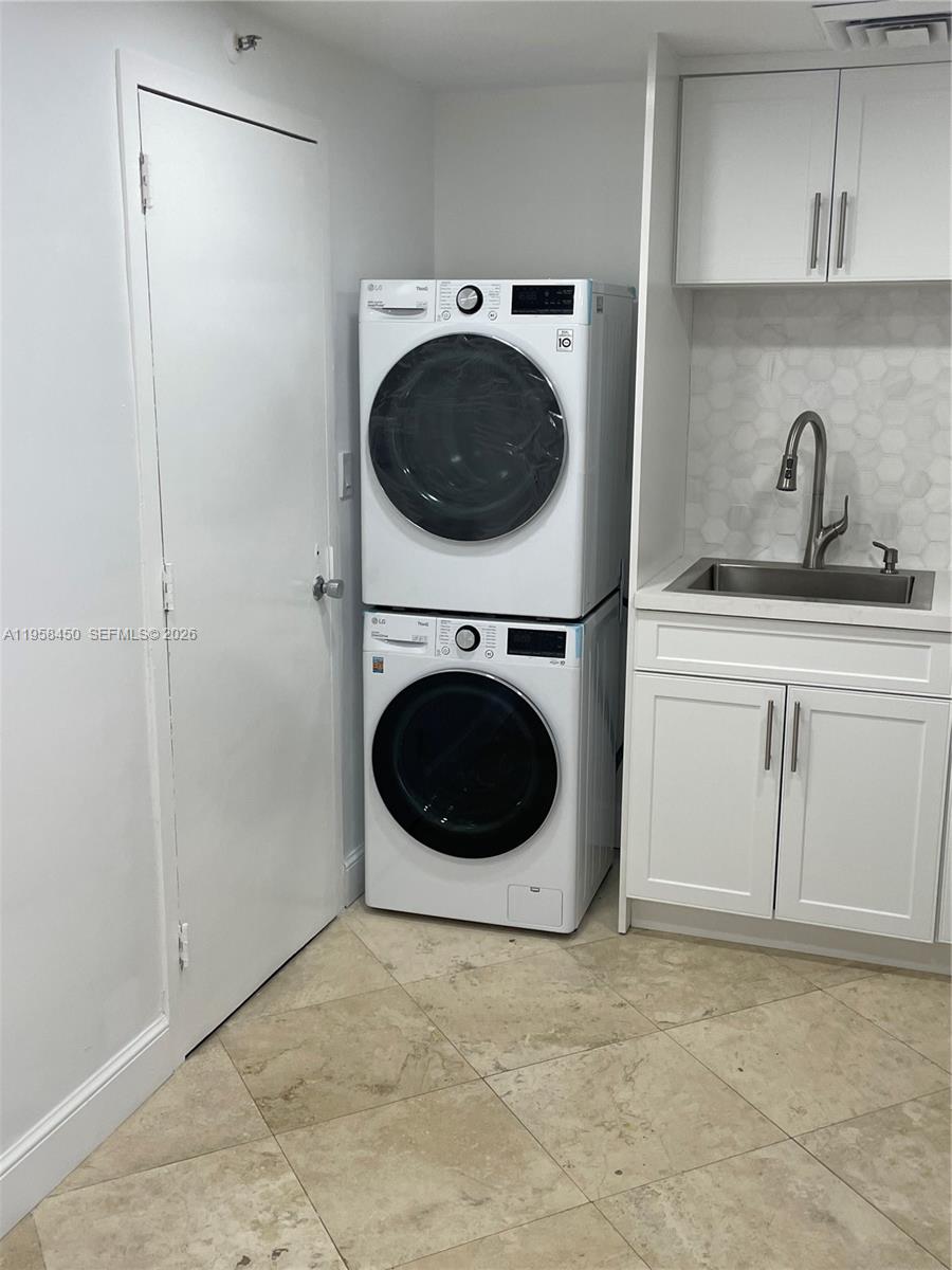 2451 Brickell Avenue, Unit PHM Miami, FL 33129 - Photo 34 of 52 a utility room with sink dryer and washer