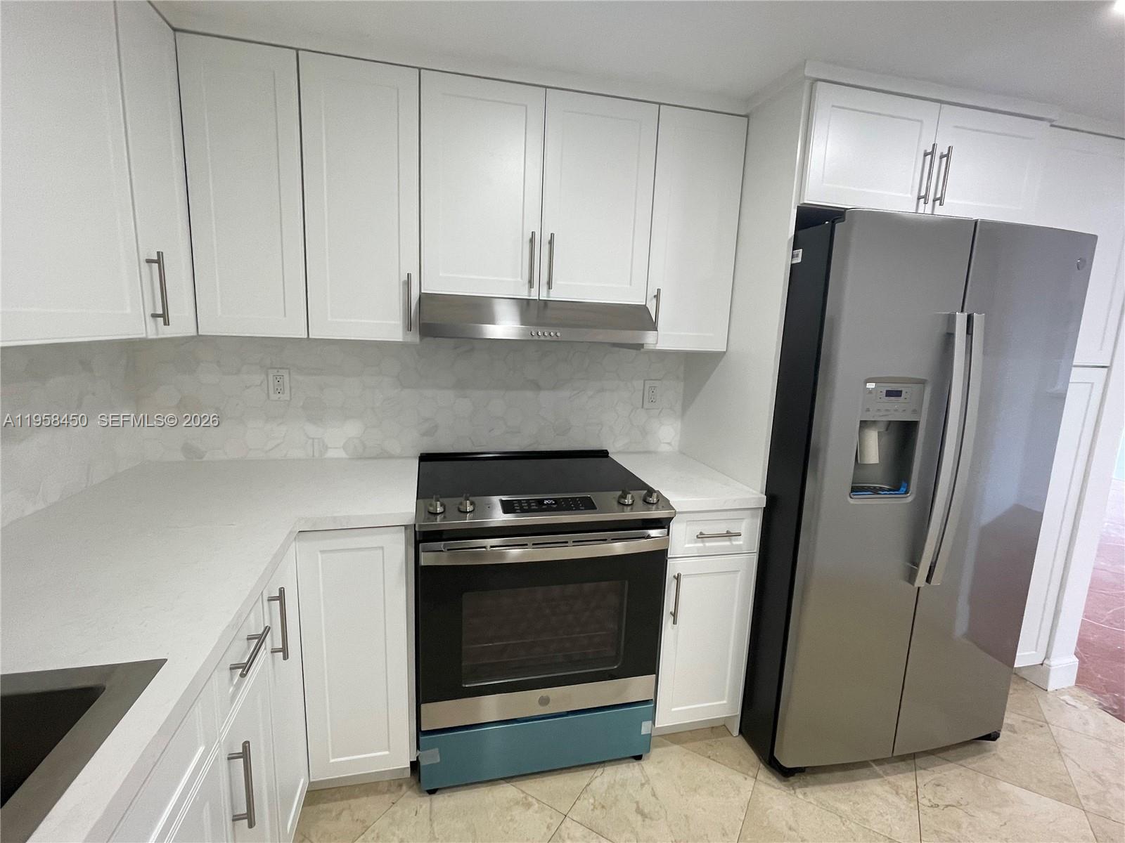 2451 Brickell Avenue, Unit PHM Miami, FL 33129 - Photo 37 of 52 a kitchen with stainless steel appliances granite countertop a refrigerator a stove and a sink