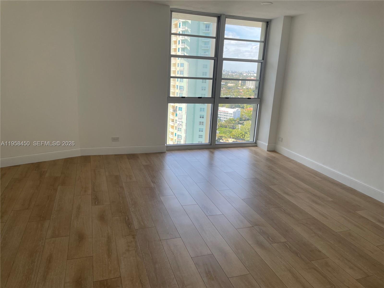 2451 Brickell Avenue, Unit PHM Miami, FL 33129 - Photo 40 of 52 wooden floor in an empty room with a window