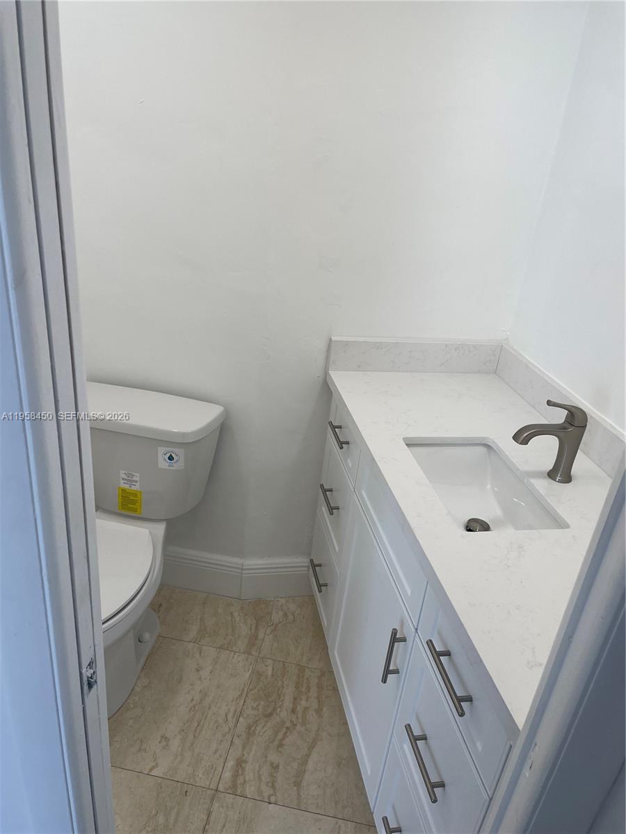 2451 Brickell Avenue, Unit PHM Miami, FL 33129 - Photo 44 of 52 a bathroom with a sink a toilet and a mirror