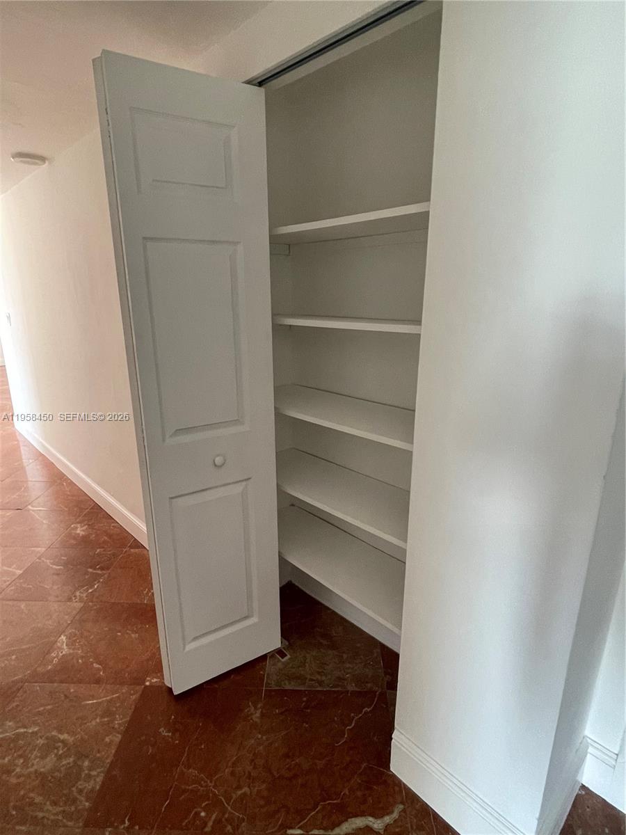 2451 Brickell Avenue, Unit PHM Miami, FL 33129 - Photo 45 of 52 a view of walk in closet with empty racks
